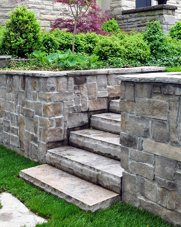 Multi-level garden with stone retainer walls in Berkshire