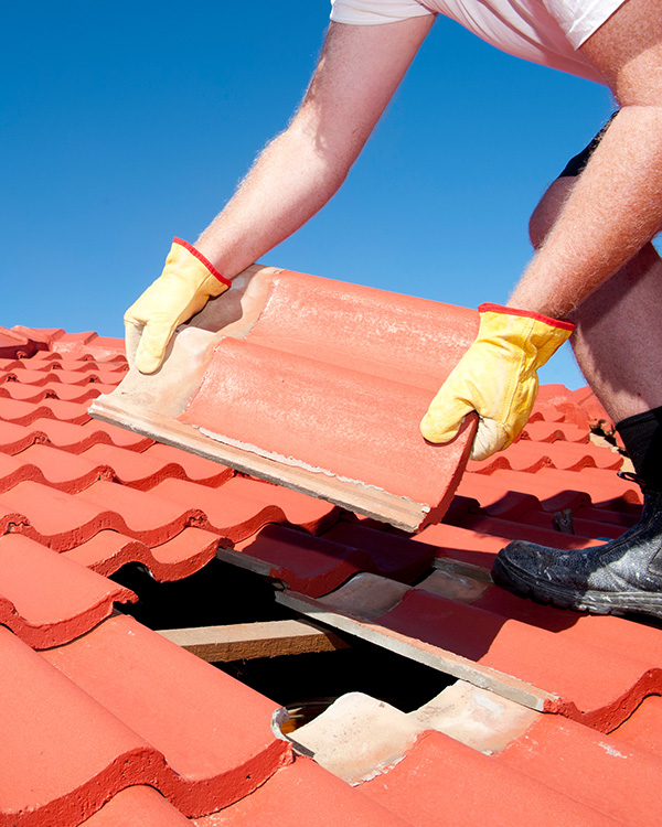 Roofer placing tile in Berkshire