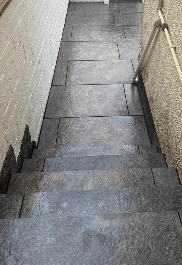 Paved steps down side ally and patio area